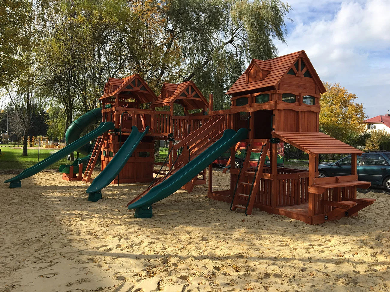 Medinė žaidimų aikštelė su čiuožyklomis ir smėlio dėže parke