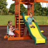 Child on the Super Safe Speedy Slide of the Sunnydale Cedar Swing Set, with the snack stand alongside